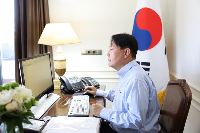This photo, provided by the presidential office, shows President Yoon Suk-yeol looking at a computer monitor at his hotel in Madrid on June 28, 2022. 