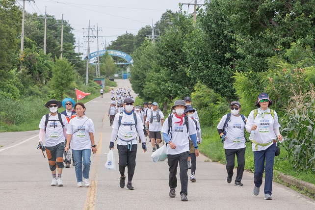 This photo provided by the Goseong County office shows participants in a walking event on the peace-themed DMZ trail in Goseong, Gangwon Province, on July 23, 2022.