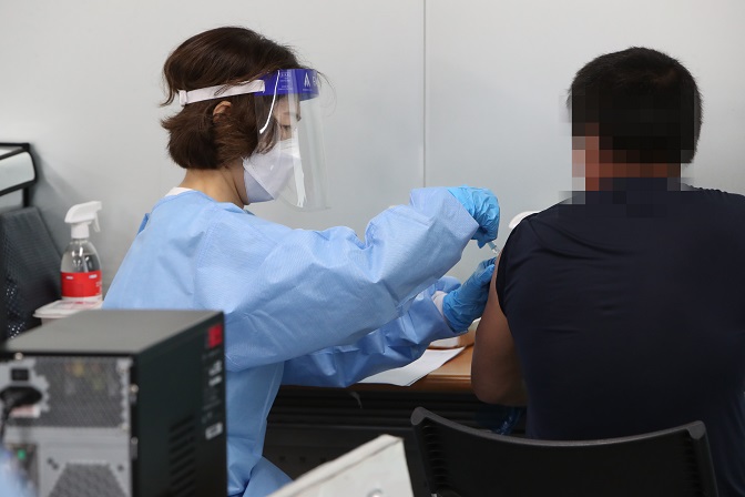 This Sept. 5, 2021, file photo shows a man getting a coronavirus vaccine in the southwestern city of Gwangju. (Yonhap)