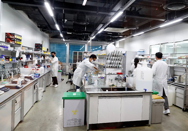 Researchers work at the lab of SK Bioscience in Seongnam, south of Seoul, on July 13, 2022, in this photo provided by the health ministry. 