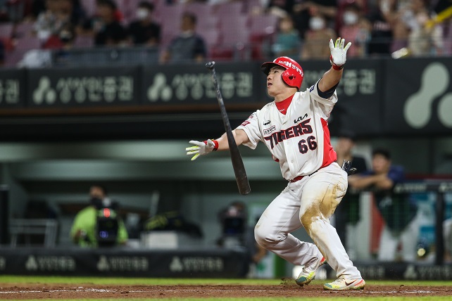 In this Aug. 18, 2022, file photo provided by the Kia Tigers, Lee Chang-jin of the Tigers flips his bat after hitting a three-run, walkoff home run against the NC Dinos during the bottom of the 10th inning of a Korea Baseball Organization regular season game at Gwangju-Kia Champions Field in Gwangju, 270 kilometers south of Seoul. 