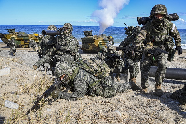 Troops secure a target area during the military's amphibious landing drills at a coastal area in Pohang, 272 kilometers southeast of Seoul, on Oct. 26, 2022, in this photo provided by the Marine Corps.