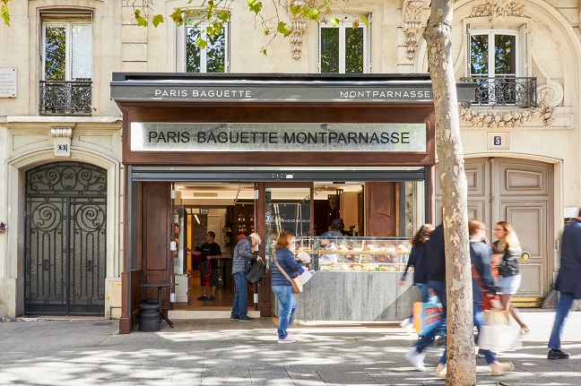 This photo provided by SPC Group shows people walking outside the Paris Baguette Montparnasse store in Paris on Oct. 4, 2022.