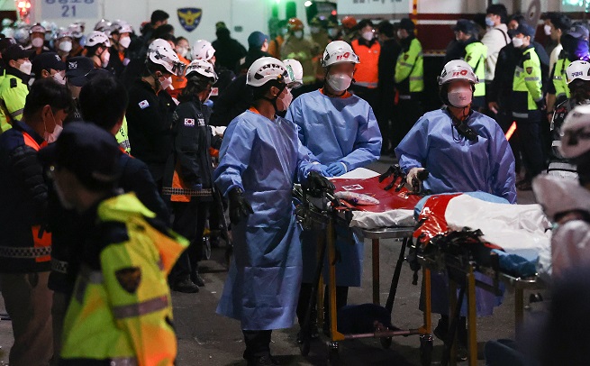 Medical workers stand at the crowd crush scene in Seoul's Itaewon district on Oct. 30, 2022, to move patients. (Yonahp)