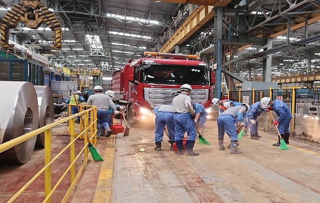 Workers remove mud at POSCO in Pohang, 374 kilometers southeast of Seoul, on Sept. 27, 2022, after many parts of the steel mill were flooded by torrential rains by the super strong Typhoon Hinnamnor, in this photo provided by the steelmaker. 