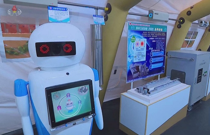 This image, captured from North Korea's Korean Central Television on Nov. 25, 2022, shows an artificially intelligent robot (L) used for COVID-19 quarantines that was displayed during an exhibition on scientific technologies of the country's quarantine and health sectors on Nov. 23. (Yonhap)