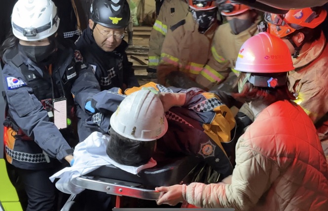 This photo provided by fire authorities shows a miner being carried into a hospital on Nov. 4, 2022 after being rescued from a collapsed mine nine days after being trapped.