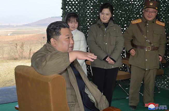 North Korean leader Kim Jong-un (front), accompanied by his wife Ri Sol-ju (C, rear) and his daughter (L, rear), speaks during the launch of a new type of the Hwasong-17 intercontinental ballistic missile (ICBM) at Pyongyang International Airport on Nov. 18, 2022, in this photo released by the North's official Korean Central News Agency. (Yonhap)