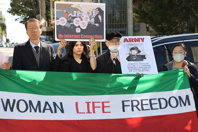 Members of the Lawyers for Human Rights and Unification of Korea stage a rally outside the Iranian Embassy in Seoul on Oct. 18, 2022, to protest the death of a young woman who was detained by morality police in Iran last month for allegedly wearing her hijab, or headscarf, improperly and call on the Middle Eastern country to guarantee women's human rights. (Yonhap)
