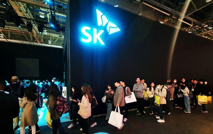 Visitors wait in line to browse SK's booth at CES 2023 that ran from Jan. 5-8 in Las Vegas, in this photo provided by SK.