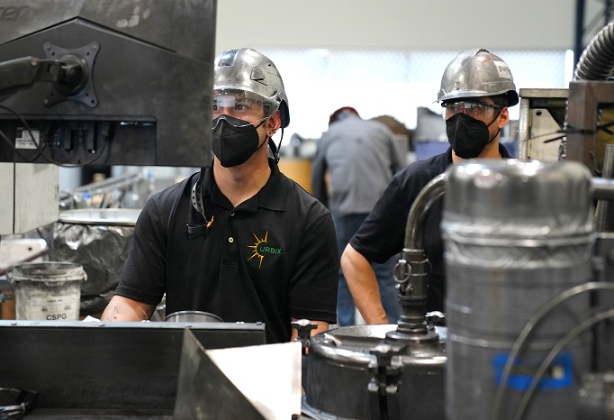 Urbix employees monitor graphite processing systems at the company's pilot facility in Arizona, in this photo provided by Urbix Inc. on Jan. 19, 2023.