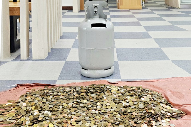 This photo provided by the Taebaek City Office shows a gas cylinder that the elderly person used as a piggy bank.