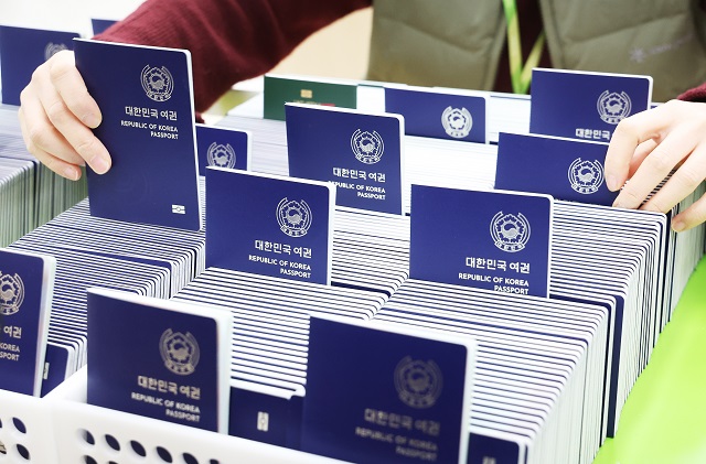 An official checks passports to be issued at the Suwon City Hall in Suwon, 45 kilometers south of Seoul, on Jan. 4, 2023. (Yonhap)