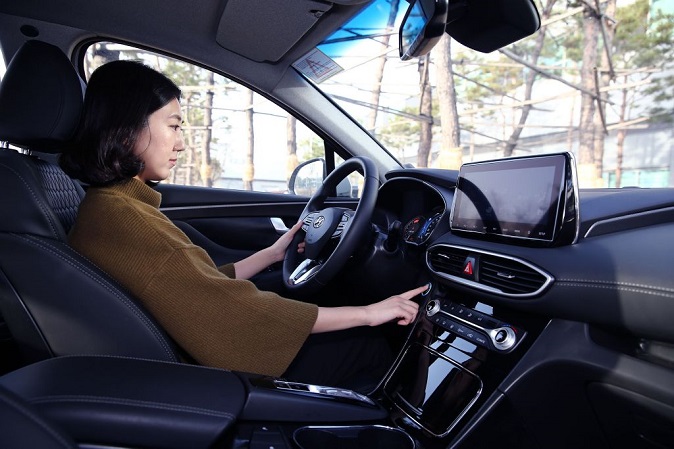 A motorist demonstrates Hyundai Motor Co.'s fingerprint sensing system, which enables users to unlock car doors and start the engine, in this photo provided by the carmaker.