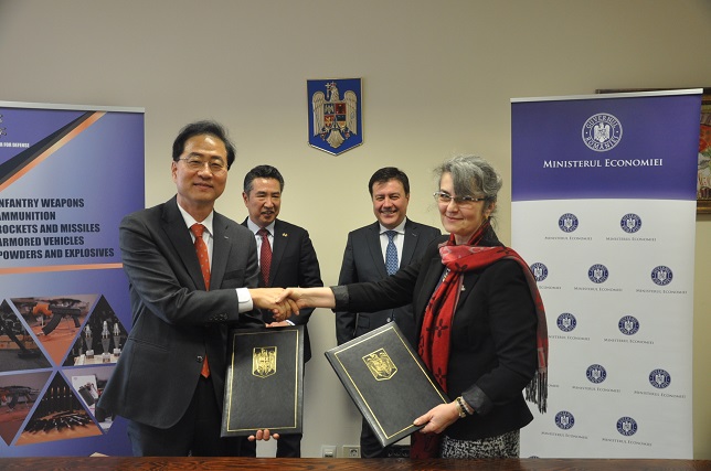 Lee Hyeon-soo (L), head of LIG Nex1's Global Business Division, shakes hands with Florentina Micu, CEO of ROMARM, after signing a memorandum of understanding (MOU) on its air defense system at Romania's ministry of economy and industry on Feb. 9, 2023, in this photo provided by LIG Nex1.