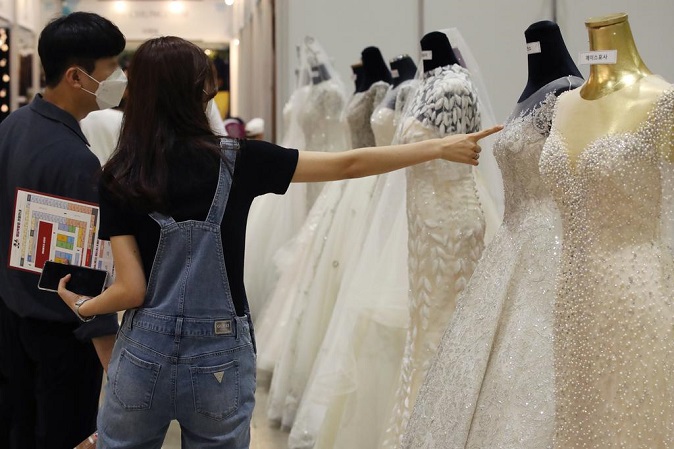 This file photo shows wedding gowns on display in a wedding fair held in Seoul on Jul. 19, 2020. (Yonhap)