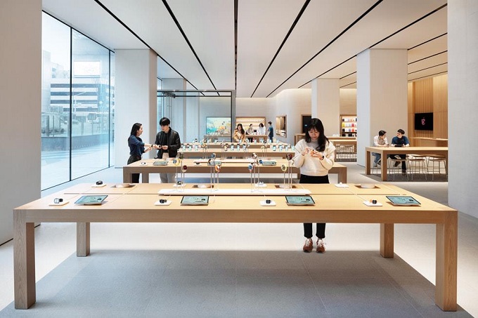 This undated photo provided by Apple Inc. shows customers checking out products at Apple Gangnam.