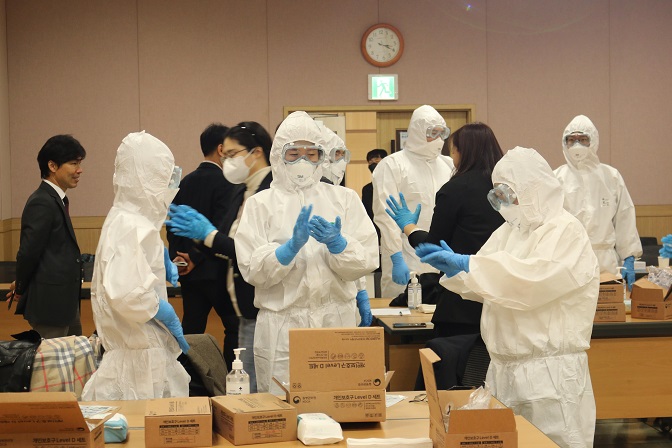 In this photo provided by the Korea Disease Control and Prevention Agency (KDCA), participants put on protective gear during a press event held in Osong, some 108 kilometers south of Seoul, on March 27, 2023.