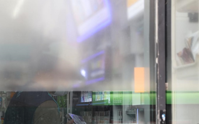 This photo taken in March 5, 2023 shows a convenience store in Seoul affixed with translucent sheets to its window. (Yonhap)