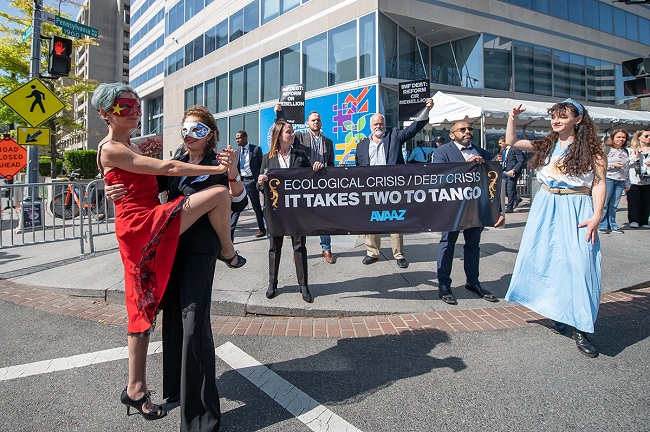 Two Avaaz dancers impersonate China and IMF Managing Director, Kristalina Georgieva, while performing “El tango de la deuda”, and a third dancer, representing Argentina, tries to be a part of the dance. Thus, Avaaz exemplifies the growing difficulty of developing countries in stabilizing their economies, which are increasingly affected by climate change on Wednesday, April 12, 2023, in Washington. (Joy Asico/AP Images for AVAAZ)