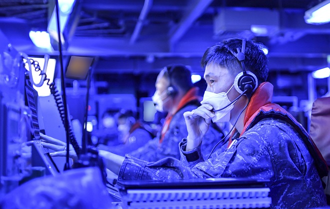 Crew members of the Sejong the Great destroyer, sailing in waters just south of Busan, 320 km southeast of Seoul, take part in anti-submarine and missile defense drills inside the warship's combat command center on May 16, 2023, in this photo released by the Navy on May 18.