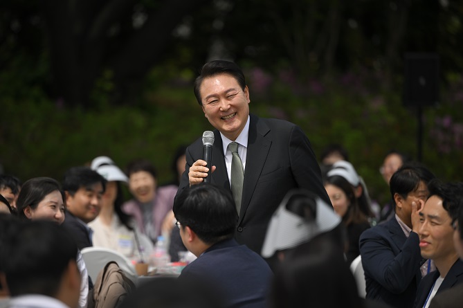 President Yoon Suk Yeol (C) speaks during a luncheon meeting with reporters covering him at the presidential office in Seoul on May 2, 2023, in this photo released by his office.