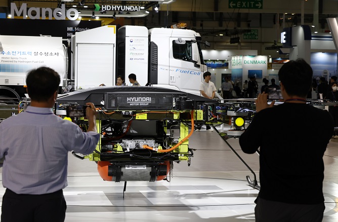 People look at an urban air mobility exhibit at the Hyundai Motor Co. booth at the World Climate Industry Expo at the BEXCO exhibition center in Busan, 320 kilometers southeast of Seoul, on May 25, 2023. (Yonhap)