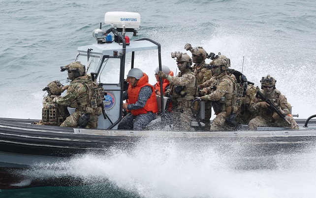 The South Korean Navy and coast guard conduct a drill aboard a speedboat to crack down on a ship suspected of carrying weapons of mass destruction in line with the Proliferation Security Initiative on seas off South Korea's southern Jeju Island on May 31, 2023. (Yonhap)