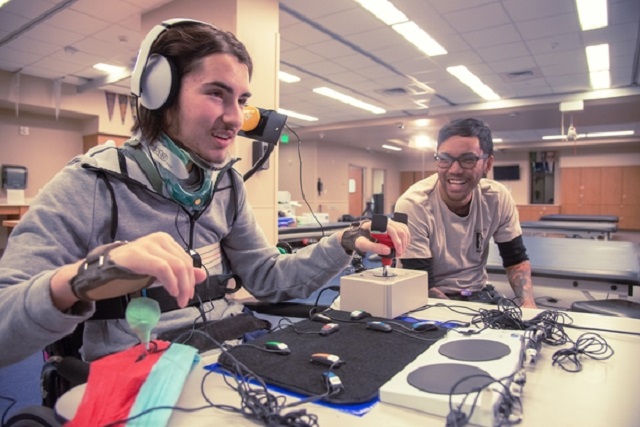 A disabled individual is seen in this Microsoft Corp-provided photo playing a video game using the Xbox Adaptive Controller.
