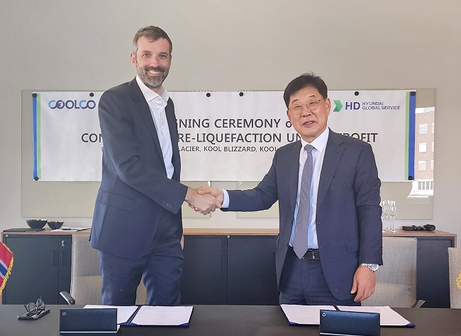 Lee Ki-dong (R), CEO of HD Hyundai Global Service Co., and Richard Tyrrell, CEO of CoolCo., shake hands during contract signing ceremony on June, 6, 2023, in this photo provided by HD Hyundai Global Service.