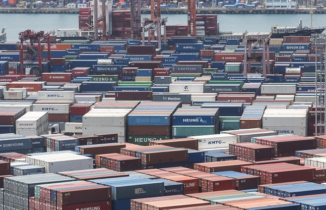 In this file photo, containers for export are stacked at a pier in South Korea's largest port city of Busan, 320 kilometers south of Seoul, on May 10, 2023. (Yonhap)