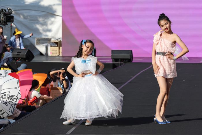 During the 'We Are Green Festival' Zero Waste Fashion Show at Seoul Plaza, kid models struts the runway adorned in fashionable attire ingeniously crafted from bubble wrap.
