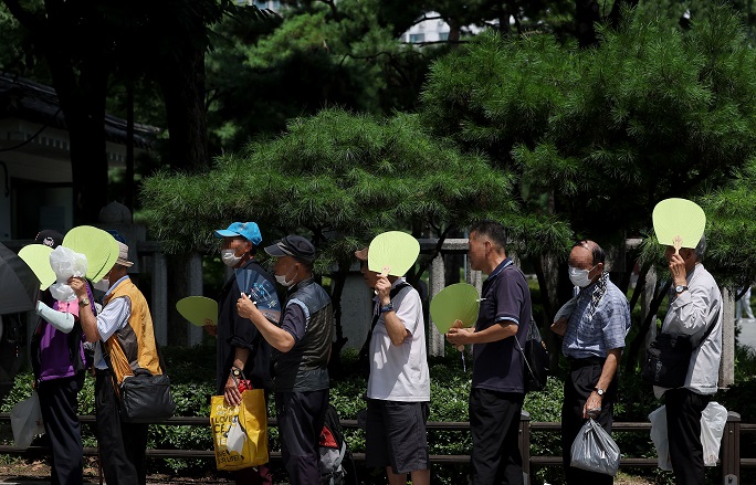 Senior Citizens Using Subway to Avoid Scorching Summer Heat