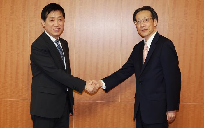 Kim Joo-hyun (L), chairman of Seoul's Financial Services Commission (FSC), and Teruhisa Kurita, Commissioner of Tokyo's Financial Services Agency, shake hands at a meeting in Tokyo on Oct. 3, 2023, in this photo provided by the FSC. (Yonhap)