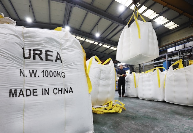 A company official moves bags of urea used to make urea solution for diesel vehicles at a company in the city of Ansan, Gyeonggi Province, on Dec. 6, 2023. (Image courtesy of Yonhap) 