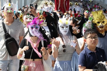 Seoul Residents Celebrate with Festive Masks and Music on Car-Free Jamsugyo Bridge