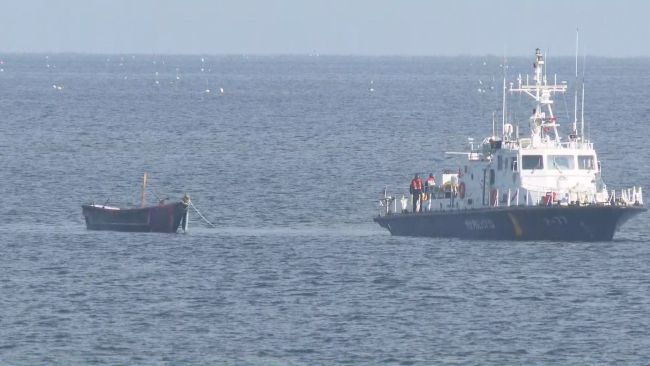 This Oct. 24, 2023, file photo, provided by Yonhap News TV, shows the military towing a North Korean wooden boat that crossed the Northern Limit Line. (Image courtesy of Yonhap)