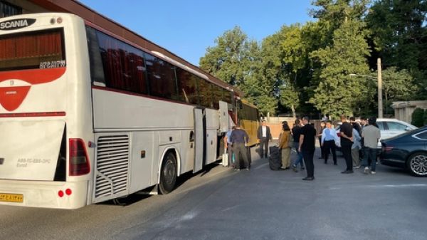 This photo, provided by the foreign ministry in Seoul on June 19, 2025, shows South Koreans and their Iranian family members boarding a bus during their evacuation from Iran to Turkmenistan. (Yonhap)