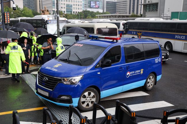 A justice ministry vehicle carrying jailed former first lady Kim Keon Hee enters the building housing the office of special counsel Min Joong-ki's team in Seoul on Aug. 25, 2025. (Image courtesy of Yonhap)