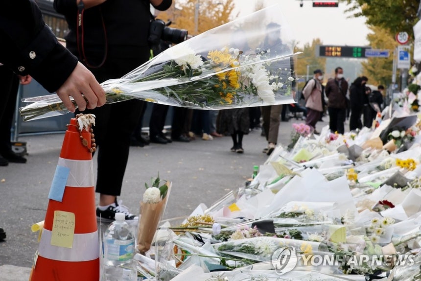 A citizen lays flowers at a memorial space for the Itaewon disaster victims set up near Exit 1 of Itaewon Station in Yongsan District, Seoul, on Nov. 9, 2022.