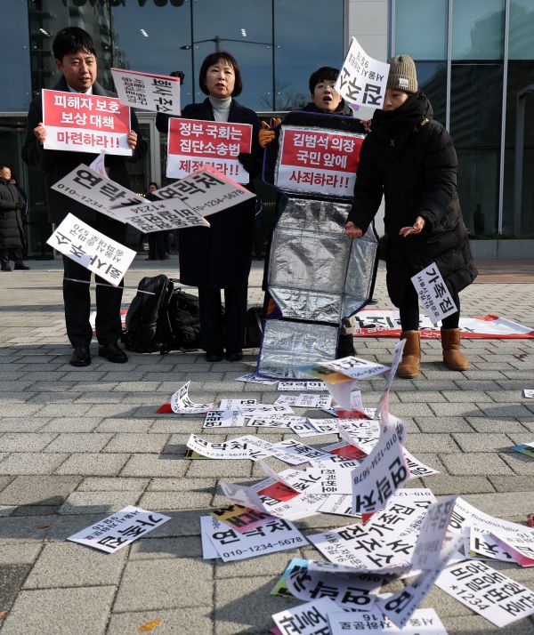 On December 3, in front of Coupang’s headquarters in Songpa District, Seoul, participants stage a performance demanding an apology and accountability during a joint press conference organized by People’s Solidarity for Participatory Democracy, the Lawyers for a Democratic Society’s Committee on Economic Justice, and the Korea Consumer Federation to announce the launch of a collective dispute mediation request over Coupang’s personal data leak. Various categories of personal information are written on the ground. (Yonhap)