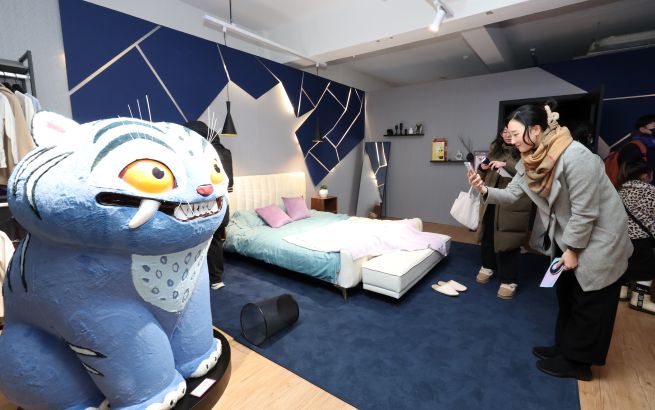 Visitors pose for photos at the official Seoul pop-up store for the Netflix animated film K-Pop Demon Hunters, which opened on Jan. 4 in Seongsu-dong, Seoul. (Yonhap)